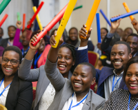 ffice employees engaging in indoor team building games and problem-solving exercises in Uganda.