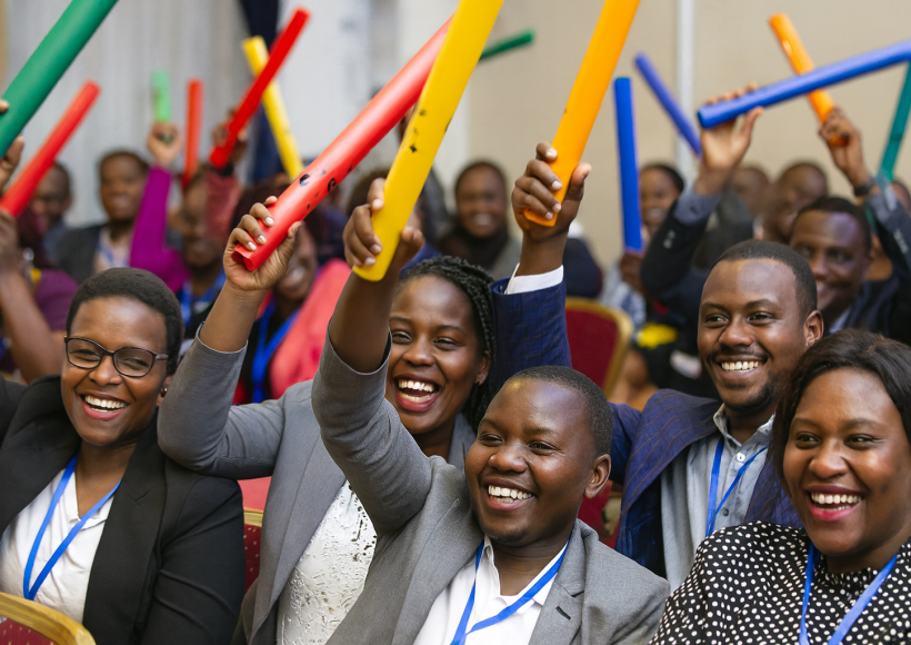 ffice employees engaging in indoor team building games and problem-solving exercises in Uganda.
